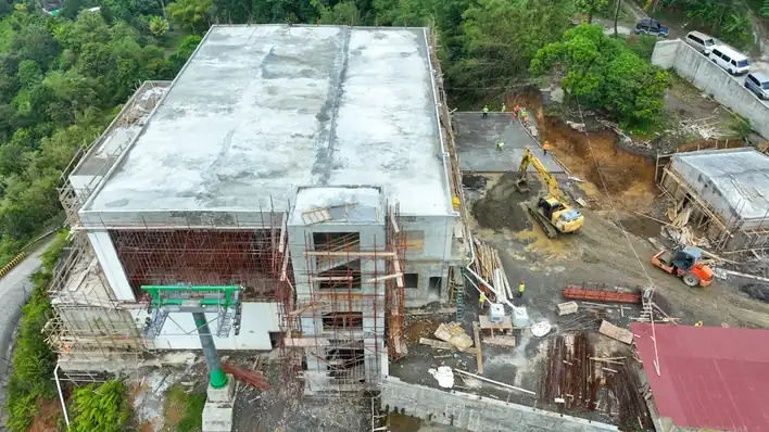 Aerial view of the Bottom Station emerging within the rainforest.